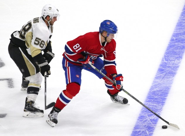 Sep 28, 2015; Quebec City, Quebec, CAN; Montreal Canadiens center Lars Eller (81) plays the puck against Pittsburgh Penguins defenseman Kris Letang (58) during the third period at Videotron Centre. Mandatory Credit: Jean-Yves Ahern-USA TODAY Sports