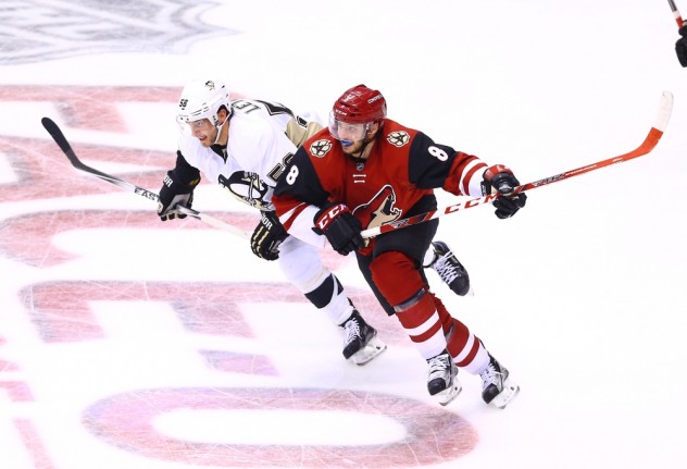 Oct 10, 2015; Glendale, AZ, USA; Arizona Coyotes center Tobias Rieder (8) battles for position against Pittsburgh Penguins defenseman Kris Letang (58) in the second period during the home opener at Gila River Arena. Mandatory Credit: Mark J. Rebilas-USA TODAY Sports