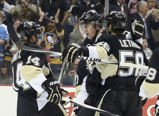 Oct 13, 2015; Pittsburgh, PA, USA; Pittsburgh Penguins defenseman Kris Letang (58) celebrates after scoring a goal with teammates left wing Chris Kunitz (14) and center Evgeni Malkin (71) against the Montreal Canadiens during the second period at the CONSOL Energy Center. Mandatory Credit: Charles LeClaire-USA TODAY Sports