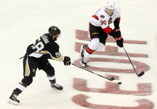 Oct 15, 2015; Pittsburgh, PA, USA; Pittsburgh Penguins defenseman Kris Letang (58) skates with the puck as Ottawa Senators right wing Alex Chiasson (90) defends during the third period at the CONSOL Energy Center. The Penguins won 2-0. Mandatory Credit: Charles LeClaire-USA TODAY Sports