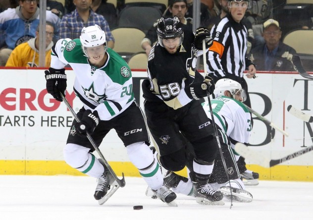 Oct 22, 2015; Pittsburgh, PA, USA; Dallas Stars center Cody Eakin (20) skates with the puck away from Pittsburgh Penguins defenseman Kris Letang (58) during the third period at the CONSOL Energy Center. The Stars won 4-1. Mandatory Credit: Charles LeClaire-USA TODAY Sports