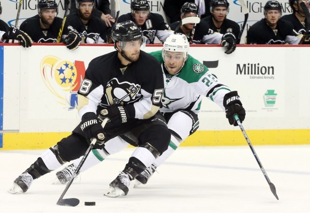 Oct 22, 2015; Pittsburgh, PA, USA; Pittsburgh Penguins defenseman Kris Letang (58) skates with the puck as Dallas Stars center Colton Sceviour (22) chases during the third period at the CONSOL Energy Center. The Stars won 4-1. Mandatory Credit: Charles LeClaire-USA TODAY Sports