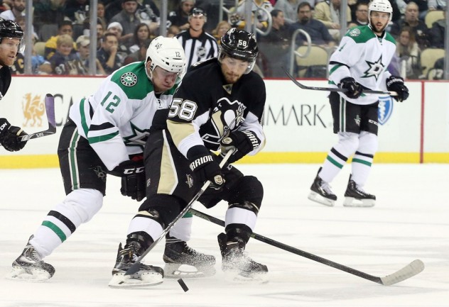 Oct 22, 2015; Pittsburgh, PA, USA; Dallas Stars center Radek Faksa (12) and Pittsburgh Penguins defenseman Kris Letang (58) fight to control a loose puck during the first period at the CONSOL Energy Center. Mandatory Credit: Charles LeClaire-USA TODAY Sports