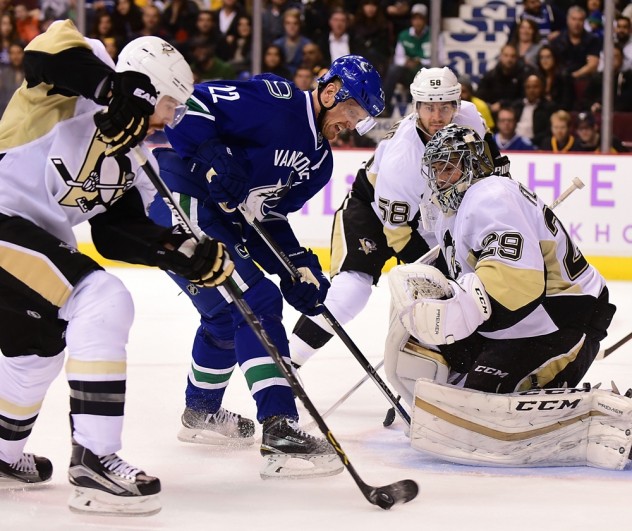 Nov 4, 2015; Vancouver, British Columbia, CAN; Pittsburgh Penguins defenseman Ian Cole (28) picks up the puck after a shot by Vancouver Canucks forward Daniel Sedin (22) against Pittsburgh Penguins goaltender Marc-Andre Fleury (29) during the second period at Rogers Arena. Mandatory Credit: Anne-Marie Sorvin-USA TODAY Sports