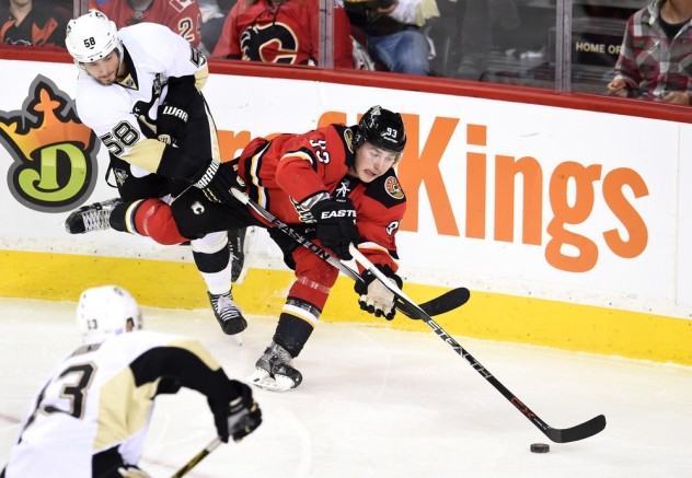 Nov 7, 2015; Calgary, Alberta, CAN; Calgary Flames center Sam Bennett (93) battles for the puck with Pittsburgh Penguins defenseman Kris Letang (58) during the second period at Scotiabank Saddledome. Mandatory Credit: Candice Ward-USA TODAY Sports
