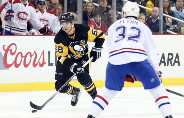 Nov 11, 2015; Pittsburgh, PA, USA; Pittsburgh Penguins defenseman Kris Letang (58) skates up ice with the puck as Montreal Canadiens right wing Brian Flynn (32) defends during the third period at the CONSOL Energy Center. The Penguins won 4-3 in a shootout. Mandatory Credit: Charles LeClaire-USA TODAY Sports
