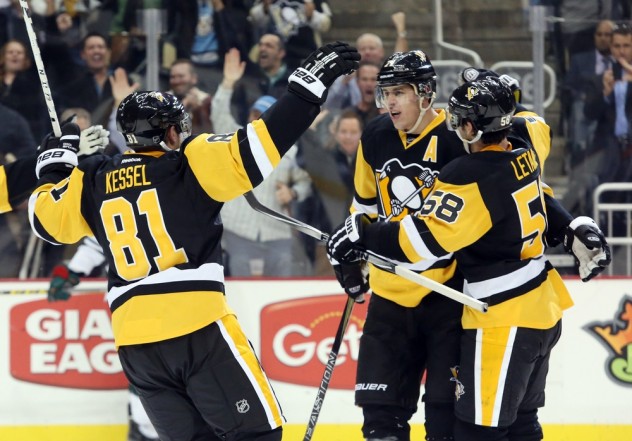 Nov 17, 2015; Pittsburgh, PA, USA; Pittsburgh Penguins right wing Phil Kessel (81) and defenseman Kris Letang (58) congratulate center Evgeni Malkin (71) after Malkin scored a power-play goal against the Minnesota Wild during the second period at the CONSOL Energy Center. The goal was Malkin's 100th career power play goal. Mandatory Credit: Charles LeClaire-USA TODAY Sports