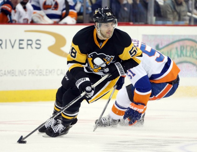 Jan 2, 2016; Pittsburgh, PA, USA; Pittsburgh Penguins defenseman Kris Letang (58) handles the puck against New York Islanders center Frans Nielsen (51) during the third period at the CONSOL Energy Center. The Penguins won 5-2. Mandatory Credit: Charles LeClaire-USA TODAY Sports