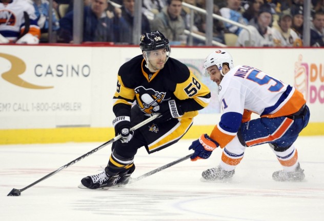Jan 2, 2016; Pittsburgh, PA, USA; Pittsburgh Penguins defenseman Kris Letang (58) handles the puck against New York Islanders center Frans Nielsen (51) during the third period at the CONSOL Energy Center. The Penguins won 5-2. Mandatory Credit: Charles LeClaire-USA TODAY Sports