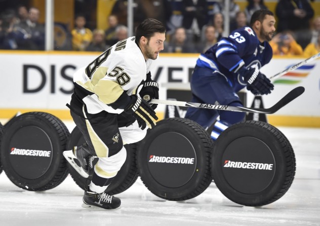 Jan 30, 2016; Nashville, TN, USA; Metropolitan Division defenseman Kris Letang (58) of the Pittsburgh Penguins races Central Division defenseman Dustin Byfuglien (33) of the Winnipeg Jets in the fastest skater competition during the 2016 NHL All Star Game Skills Competition at Bridgestone Arena. Mandatory Credit: Christopher Hanewinckel-USA TODAY Sports