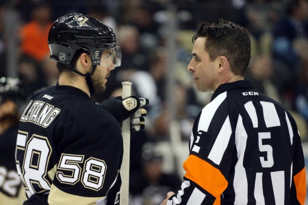 Feb 2, 2016; Pittsburgh, PA, USA; Pittsburgh Penguins defenseman Kris Letang (58) talks with referee Chris Rooney (5) during a time-out against the Ottawa Senators in the second period at the CONSOL Energy Center. The Penguins won 6-5. Mandatory Credit: Charles LeClaire-USA TODAY Sports