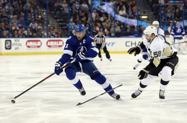 Feb 5, 2016; Tampa, FL, USA;Tampa Bay Lightning center Steven Stamkos (91) skates with the puck as Pittsburgh Penguins defenseman Kris Letang (58) defends during the first period at Amalie Arena. Mandatory Credit: Kim Klement-USA TODAY Sports