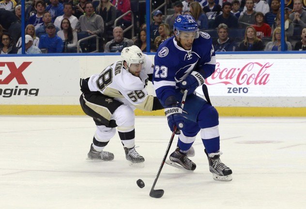 Feb 5, 2016; Tampa, FL, USA; Tampa Bay Lightning right wing J.T. Brown (23) skates with the puck as Pittsburgh Penguins defenseman Kris Letang (58) defends during the first period at Amalie Arena. Mandatory Credit: Kim Klement-USA TODAY Sports