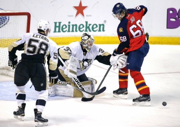 Feb 6, 2016; Sunrise, FL, USA; Pittsburgh Penguins goalie Jeff Zatkoff (37) makes a save on a shot by Florida Panthers right wing Jaromir Jagr (68) as defenseman Kris Letang (58) looks on in the third period at BB&T Center. The  Penguins won 3-2 in overtime. Mandatory Credit: Robert Mayer-USA TODAY Sports