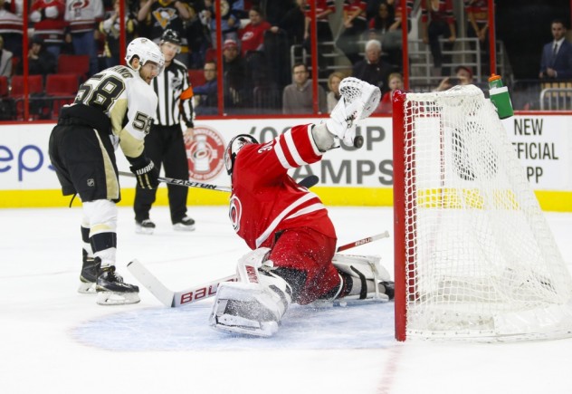 Feb 12, 2016; Raleigh, NC, USA;  Pittsburgh Penguins defensemen Kris Letang (58) watches his shoot out game winning goal against Carolina Hurricanes goalie Cam Ward (30) at PNC Arena. The Pittsburgh Penguins defeated the Carolina Hurricanes 2-1 in the shoot out. Mandatory Credit: James Guillory-USA TODAY Sports
