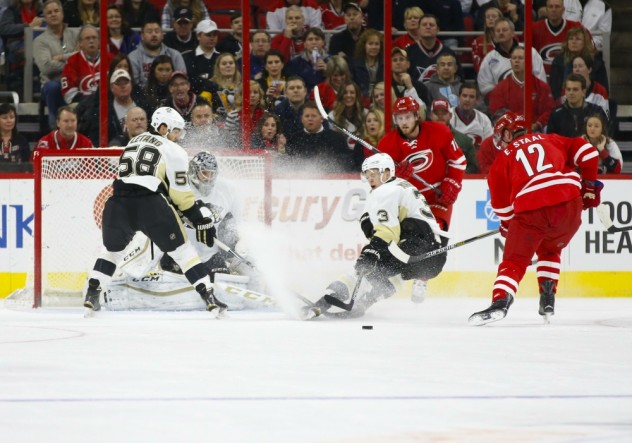 Feb 12, 2016; Raleigh, NC, USA;  Pittsburgh Penguins goalie Marc-Andre Fleury (29) and defensemen Kris Letang (58) and defensemen Olli Maatta (3) watch the rebound against Carolina Hurricanes forward Eric Staal (12) doing the first period at PNC Arena. Mandatory Credit: James Guillory-USA TODAY Sports