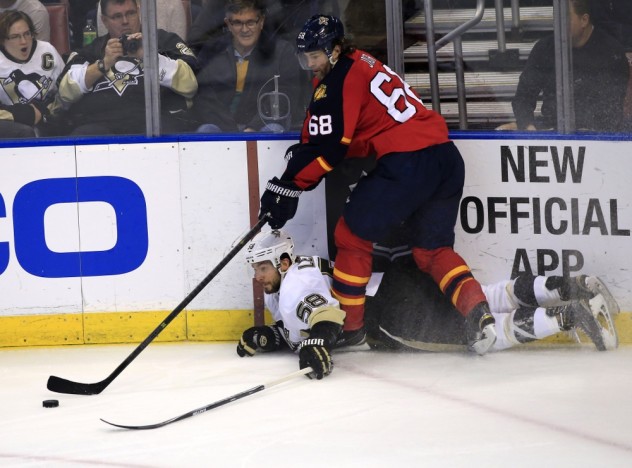 Feb 15, 2016; Sunrise, FL, USA; Florida Panthers right wing Jaromir Jagr (68) and Pittsburgh Penguins defenseman Kris Letang (58) reach for the puck in the second period at BB&T Center. Mandatory Credit: Robert Mayer-USA TODAY Sports