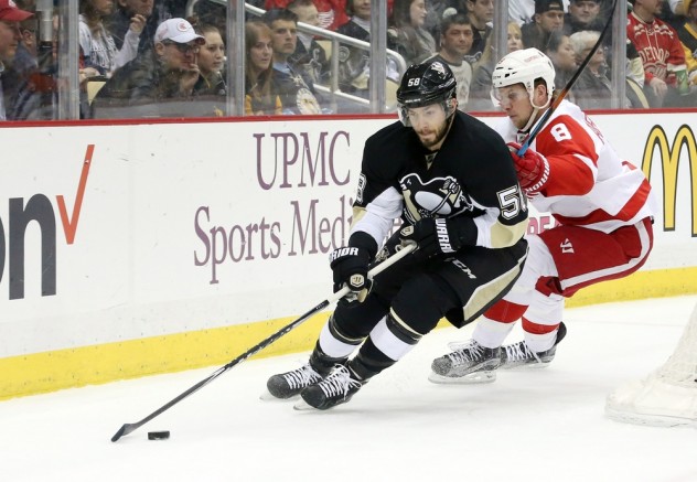 Feb 18, 2016; Pittsburgh, PA, USA; Pittsburgh Penguins defenseman Kris Letang (58) handles the puck ahead of Detroit Red Wings left wing Justin Abdelkader (8) during the first period at the CONSOL Energy Center. Mandatory Credit: Charles LeClaire-USA TODAY Sports