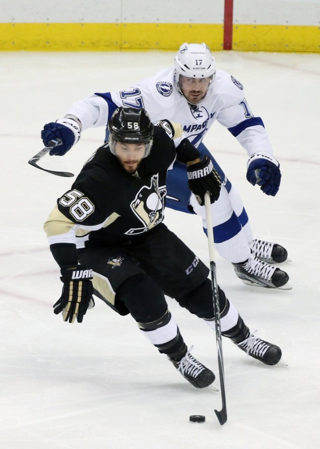 Feb 20, 2016; Pittsburgh, PA, USA; Pittsburgh Penguins defenseman Kris Letang (58) chases the puck ahead of Tampa Bay Lightning center Alex Killorn (17) during the second period at the CONSOL Energy Center. Tampa Bay won 4-2. Mandatory Credit: Charles LeClaire-USA TODAY Sports