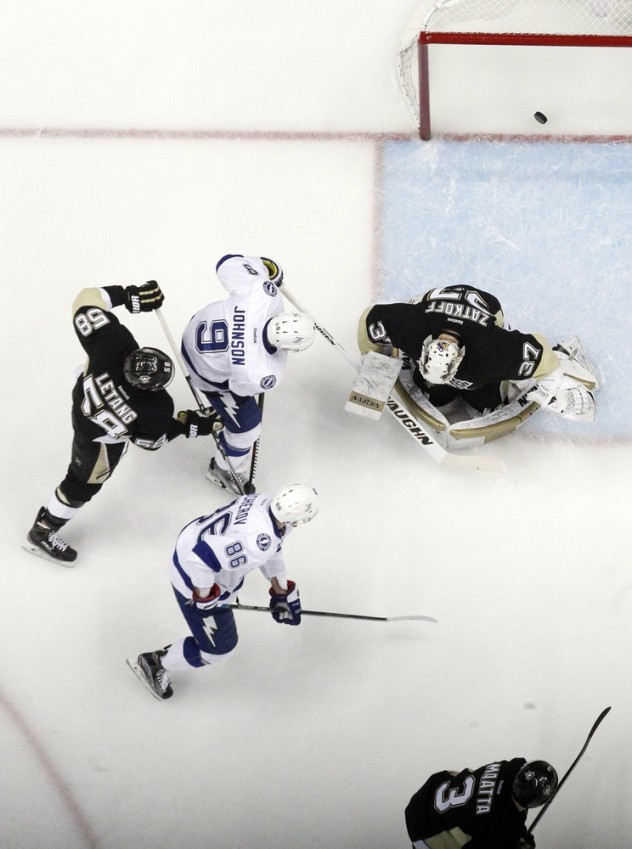 Feb 20, 2016; Pittsburgh, PA, USA; Pittsburgh Penguins defenseman Kris Letang (58) and Tampa Bay Lightning center Tyler Johnson (9) and right wing Nikita Kucherov (86) watch a shot by Lightning defenseman Matt Carle (not pictured) score behind Pens goalie Jeff Zatkoff (37) during the second period at the CONSOL Energy Center. Tampa Bay won 4-2. Mandatory Credit: Charles LeClaire-USA TODAY Sports