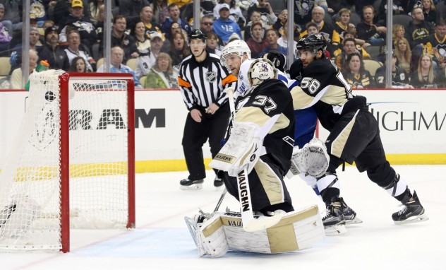 Feb 20, 2016; Pittsburgh, PA, USA; Tampa Bay Lightning center Steven Stamkos (middle) scores behind Pittsburgh Penguins goalie Jeff Zatkoff (37) as Pens defenseman Kris Letang (58) defends during the first period at the CONSOL Energy Center. The goal was the 300th career NHL goal for Stamkos. Mandatory Credit: Charles LeClaire-USA TODAY Sports
