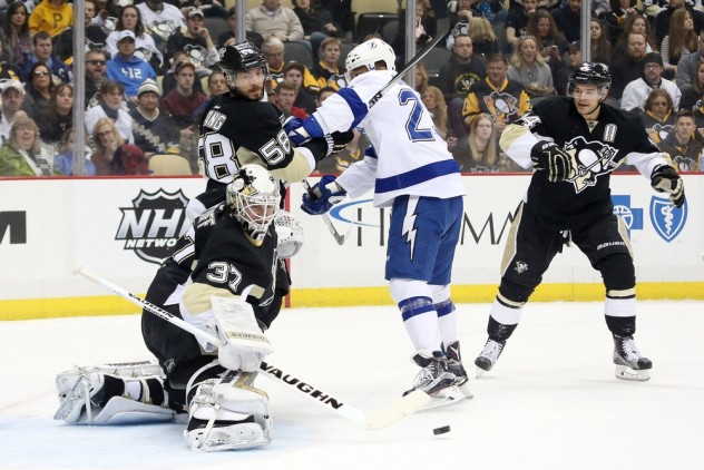 Feb 20, 2016; Pittsburgh, PA, USA; Pittsburgh Penguins goalie Jeff Zatkoff (37) makes a save as Penguins defenseman Kris Letang (58) defends Tampa Bay Lightning right wing J.T. Brown (23) during the first period at the CONSOL Energy Center. Mandatory Credit: Charles LeClaire-USA TODAY Sports
