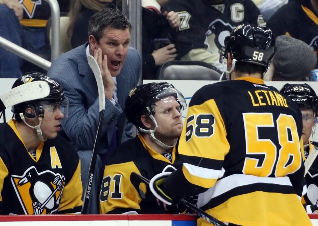Feb 27, 2016; Pittsburgh, PA, USA; Pittsburgh Penguins head coach Mike Sullivan (L) talks with defenseman Kris Letang (58) against the Winnipeg Jets during the second period at the CONSOL Energy Center. Mandatory Credit: Charles LeClaire-USA TODAY Sports