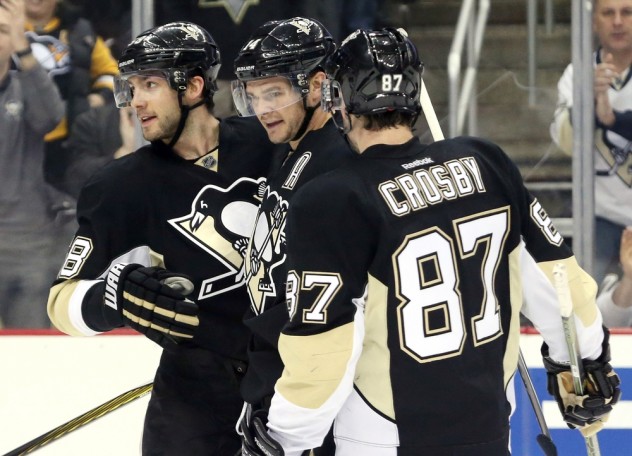 Feb 29, 2016; Pittsburgh, PA, USA; Pittsburgh Penguins defenseman Kris Letang (left) and left wing Chris Kunitz (14) and center Sidney Crosby (87) celebrate a goal by Kunitz against the Arizona Coyotes during the second period at the CONSOL Energy Center. Mandatory Credit: Charles LeClaire-USA TODAY Sports