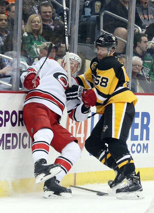 Mar 17, 2016; Pittsburgh, PA, USA; Pittsburgh Penguins defenseman Kris Letang (58) checks Carolina Hurricanes center Joakim Nordstrom (42) into the boards during the third period at the CONSOL Energy Center. The Penguins won 4-2. Mandatory Credit: Charles LeClaire-USA TODAY Sports