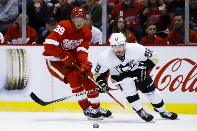 Mar 26, 2016; Detroit, MI, USA; Detroit Red Wings right wing Anthony Mantha (39) and Pittsburgh Penguins defenseman Kris Letang (58) battle for the puck in the first period at Joe Louis Arena. Mandatory Credit: Rick Osentoski-USA TODAY Sports