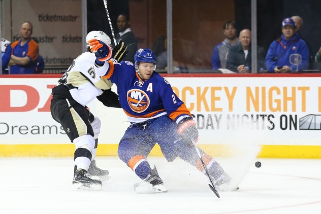 Apr 2, 2016; Brooklyn, NY, USA; New York Islanders right wing Kyle Okposo (21) and Pittsburgh Penguins defenseman Kris Letang (58) battle for the puck during the second period at Barclays Center. Mandatory Credit: Anthony Gruppuso-USA TODAY Sports