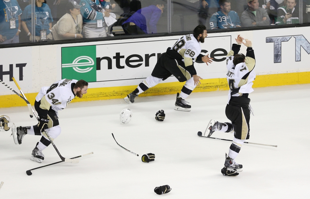 Jun 12, 2016; San Jose, CA, USA; Pittsburgh Penguins players Tom Kuhnhackl (34) , Kris Letang (58) and Chris Kunitz (14) celebrate on the ice after defeating the San Jose Sharks game six of the 2016 Stanley Cup Final at SAP Center at San Jose. Mandatory Credit: John Hefti-USA TODAY Sports