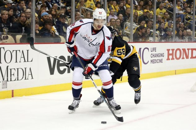 Oct 13, 2016; Pittsburgh, PA, USA; Washington Capitals center Zachary Sanford (82) moves the puck ahead of Pittsburgh Penguins defenseman Kris Letang (58) during the first period at the PPG Paints Arena. Mandatory Credit: Charles LeClaire-USA TODAY Sports