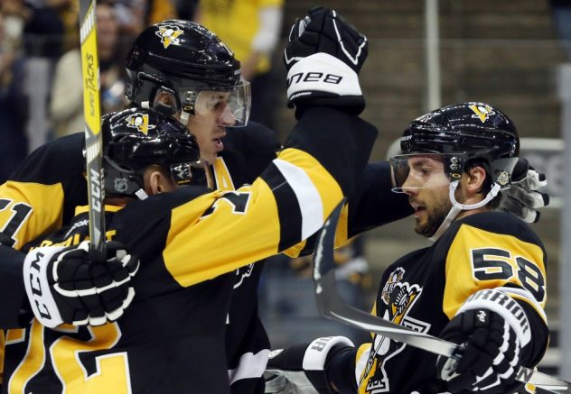 Oct 13, 2016; Pittsburgh, PA, USA; Pittsburgh Penguins right wing Patric Hornqvist (72) celebrates his goal with center Evgeni Malkin (rear) and defenseman Kris Letang (58) against the Washington Capitals during the second period at the PPG Paints Arena. Mandatory Credit: Charles LeClaire-USA TODAY Sports