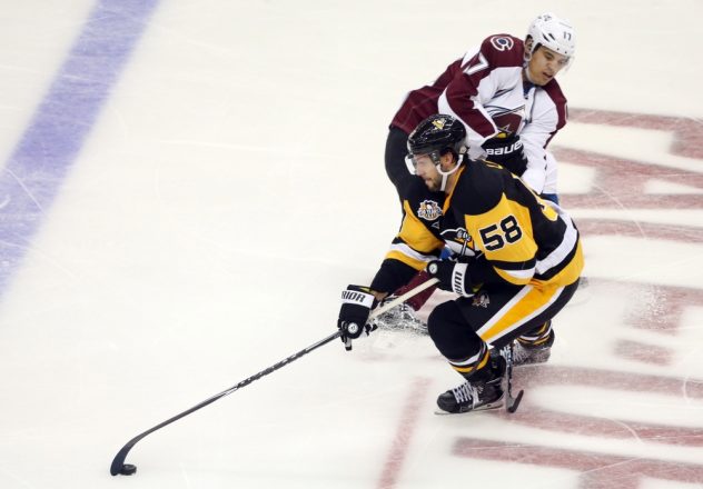 Oct 17, 2016; Pittsburgh, PA, USA; Pittsburgh Penguins defenseman Kris Letang (58) skates with the puck around Colorado Avalanche right wing Rene Bourque (17) during the second period at the PPG Paints Arena. Mandatory Credit: Charles LeClaire-USA TODAY Sports