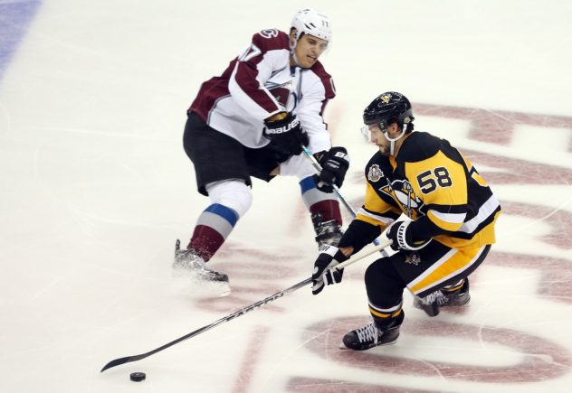 Oct 17, 2016; Pittsburgh, PA, USA; Pittsburgh Penguins defenseman Kris Letang (58) handles the puck against Colorado Avalanche right wing Rene Bourque (17) during the second period at the PPG Paints Arena. Mandatory Credit: Charles LeClaire-USA TODAY Sports