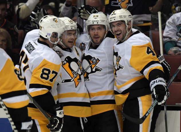 Nov 2, 2016; Anaheim, CA, USA; Pittsburgh Penguins players Sidney Crosby (87), Chris Kunitz (14), Kris Letang and Justin Schultz (4) celebrate after a goal in the third period against the Anaheim Ducks during a NHL hockey match at Honda Center. The Penguins defeated the Ducks 5-1. Mandatory Credit: Kirby Lee-USA TODAY Sports