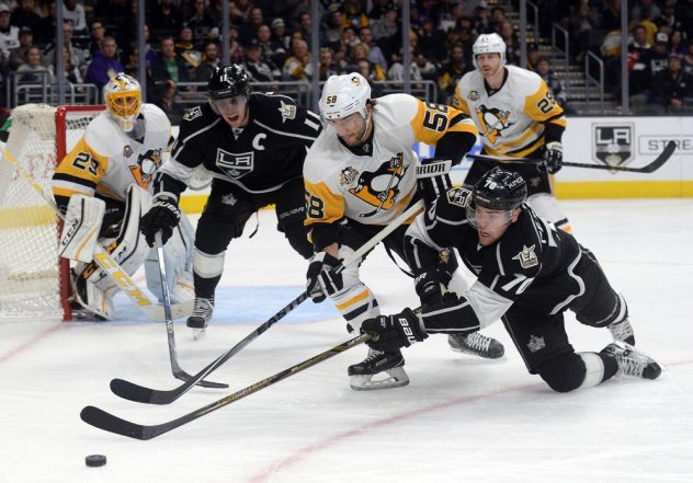 November 3, 2016; Los Angeles, CA, USA; Los Angeles Kings center Anze Kopitar (11) and left wing Tanner Pearson (70) play for the puck against Pittsburgh Penguins defenseman Kris Letang (58) during the second period at Staples Center. Mandatory Credit: Gary A. Vasquez-USA TODAY Sports
