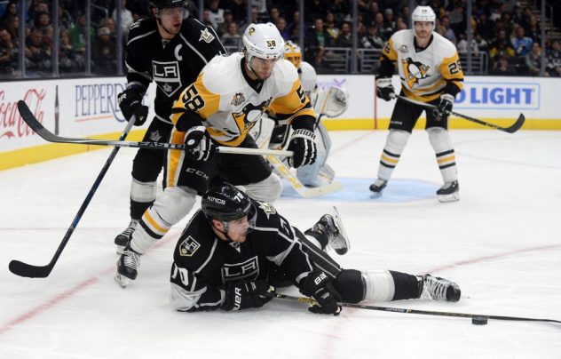November 3, 2016; Los Angeles, CA, USA; Los Angeles Kings left wing Tanner Pearson (70) keeps the puck away from Pittsburgh Penguins defenseman Kris Letang (58) during the second period at Staples Center. Mandatory Credit: Gary A. Vasquez-USA TODAY Sports