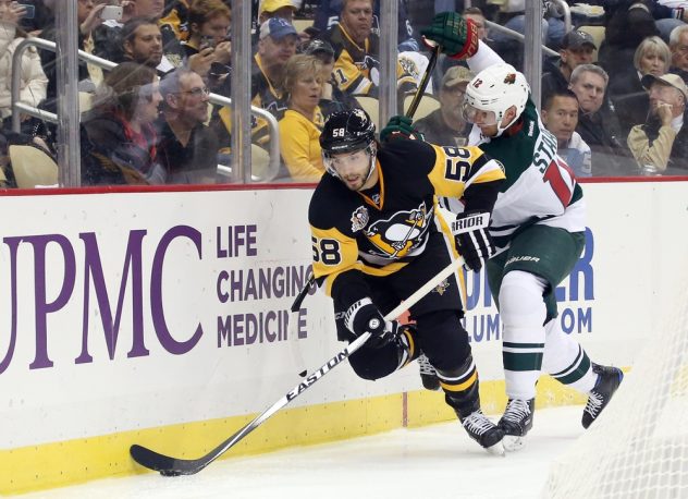 Nov 10, 2016; Pittsburgh, PA, USA;  Pittsburgh Penguins defenseman Kris Letang (58) moves the puck ahead of Minnesota Wild center Eric Staal (12) during the third period at the PPG Paints Arena. Minnesota won 4-2. Mandatory Credit: Charles LeClaire-USA TODAY Sports