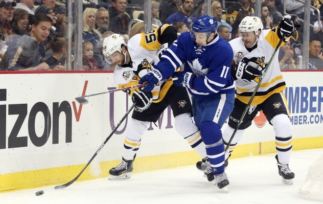 Nov 12, 2016; Pittsburgh, PA, USA; Pittsburgh Penguins defenseman Kris Letang (58) and right wing Bryan Rust (17) battle for the puck with Toronto Maple Leafs center Zach Hyman (11) /during the first period at the PPG Paints Arena. Mandatory Credit: Charles LeClaire-USA TODAY Sports
