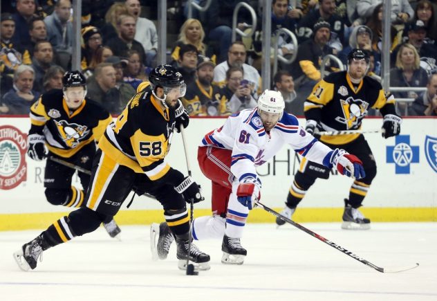 Nov 21, 2016; Pittsburgh, PA, USA; Pittsburgh Penguins defenseman Kris Letang (58) shoots the puck as New York Rangers right wing Rick Nash (61) defends during the third period at the PPG Paints Arena. The Rangers won 5-2. Mandatory Credit: Charles LeClaire-USA TODAY Sports