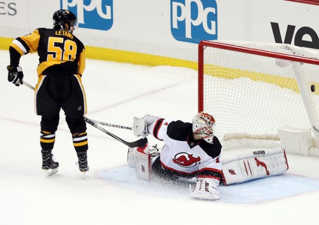Nov 26, 2016; Pittsburgh, PA, USA;  Pittsburgh Penguins defenseman Kris Letang (58) scores a goal past New Jersey Devils goalie Keith Kinkaid (1) in the shootout at the PPG PAINTS Arena. The Pens won 4-3 in a shootout. Mandatory Credit: Charles LeClaire-USA TODAY Sports