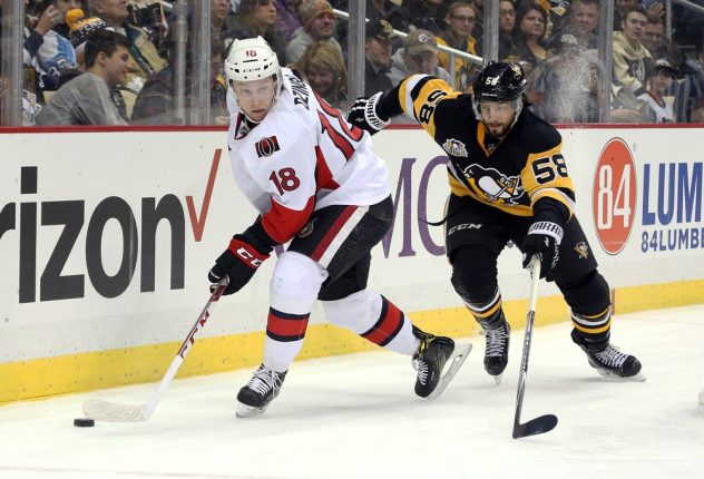 Dec 5, 2016; Pittsburgh, PA, USA; Ottawa Senators left wing Ryan Dzingel (18) handles the puck against Pittsburgh Penguins defenseman Kris Letang (58) during the first period at the PPG PAINTS Arena. Mandatory Credit: Charles LeClaire-USA TODAY Sports