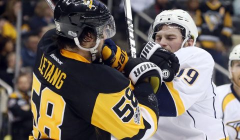 Jan 31, 2017; Pittsburgh, PA, USA; Pittsburgh Penguins defenseman Kris Letang (58) and Nashville Predators center Calle Jarnkrok (19) scuffle during the third period at the PPG PAINTS Arena. The Penguins won 4-2. Mandatory Credit: Charles LeClaire-USA TODAY Sports