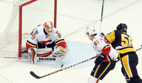 Feb 7, 2017; Pittsburgh, PA, USA; Calgary Flames goalie Chad Johnson (31) makes a save against Pittsburgh Penguins defenseman Kris Letang (58) as Flames defenseman Brett Kulak (61) defends during the second period at the PPG PAINTS Arena. Mandatory Credit: Charles LeClaire-USA TODAY Sports