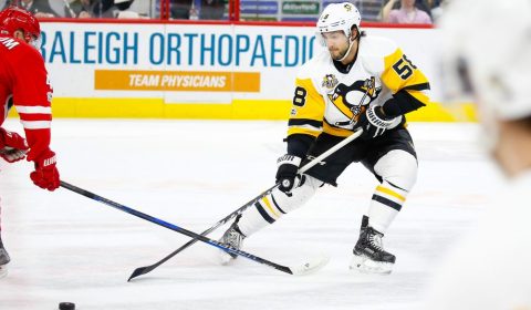 Feb 21, 2017; Raleigh, NC, USA; Pittsburgh Penguins defensemen Kris Letang (58) pokes the puck away from the Carolina Hurricanes at PNC Arena. The Pittsburgh Penguins  defeated the Carolina Hurricanes 3-1. Mandatory Credit: James Guillory-USA TODAY Sports