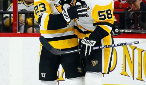 Feb 21, 2017; Raleigh, NC, USA; Pittsburgh Penguins forward Scott Wilson (23) celebrates his first period goal with teammate defensemen Kris Letang (58) against the Carolina Hurricanes at PNC Arena. Mandatory Credit: James Guillory-USA TODAY Sports