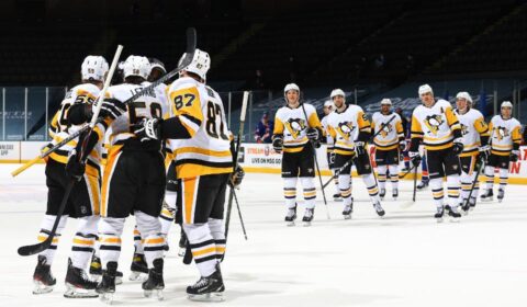 Kris Letang #58 of the Pittsburgh Penguins is congratulated by his teammates after scoring the game-winning goal in overtime to defeat the New York Islanders 4-3 at Nassau Coliseum.