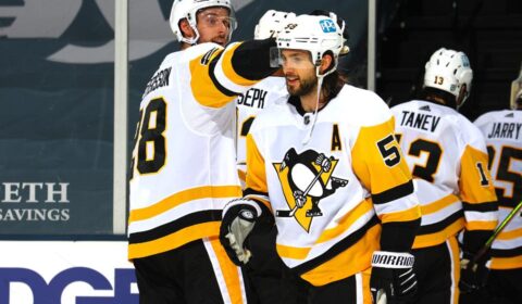 Kris Letang #58 of the Pittsburgh Penguins is congratulated by Marcus Pettersson #28 after scoring the game-winning goal in overtime to defeat the New York Islanders.